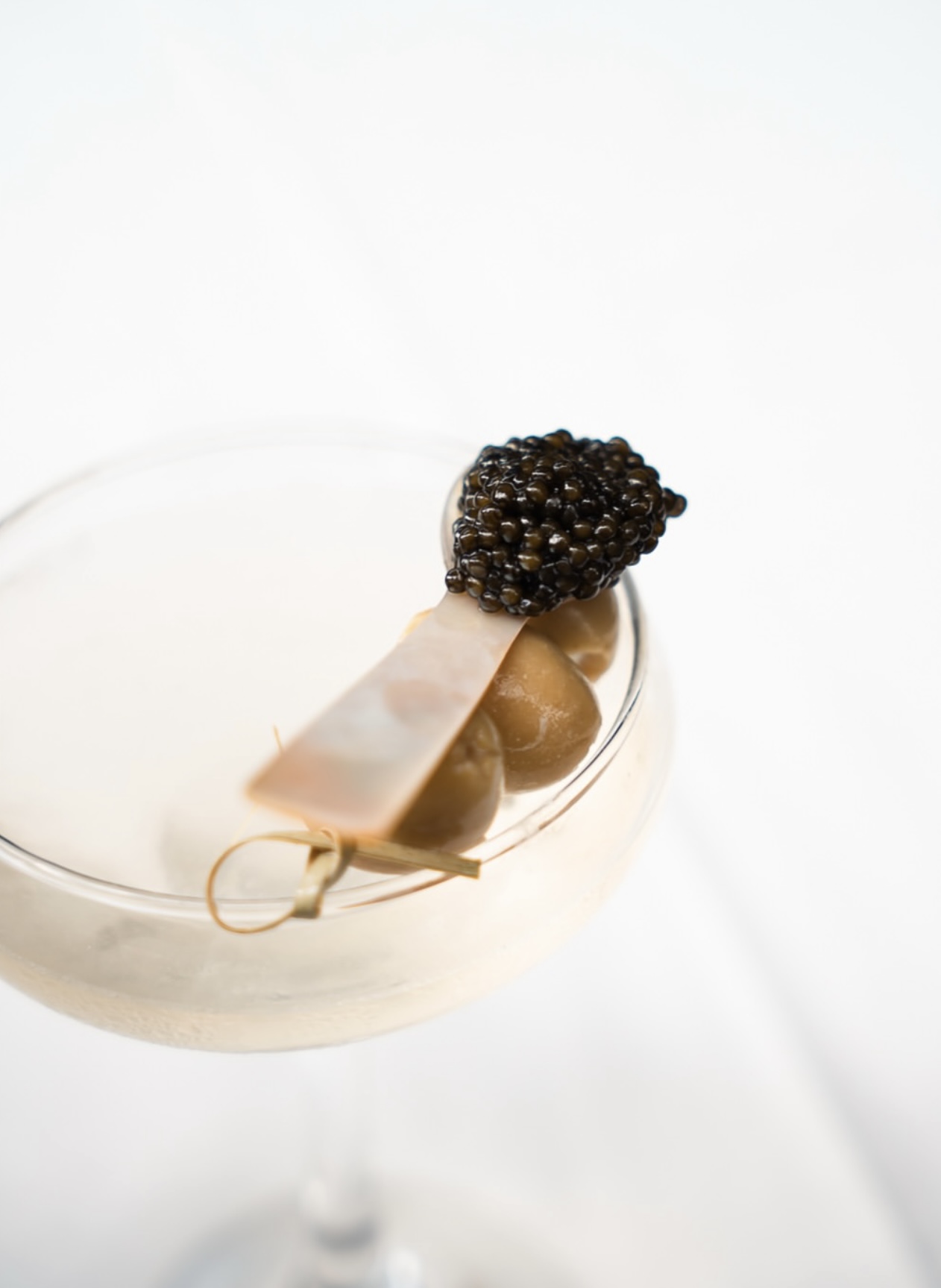 Signature cocktail styled with caviar garnish