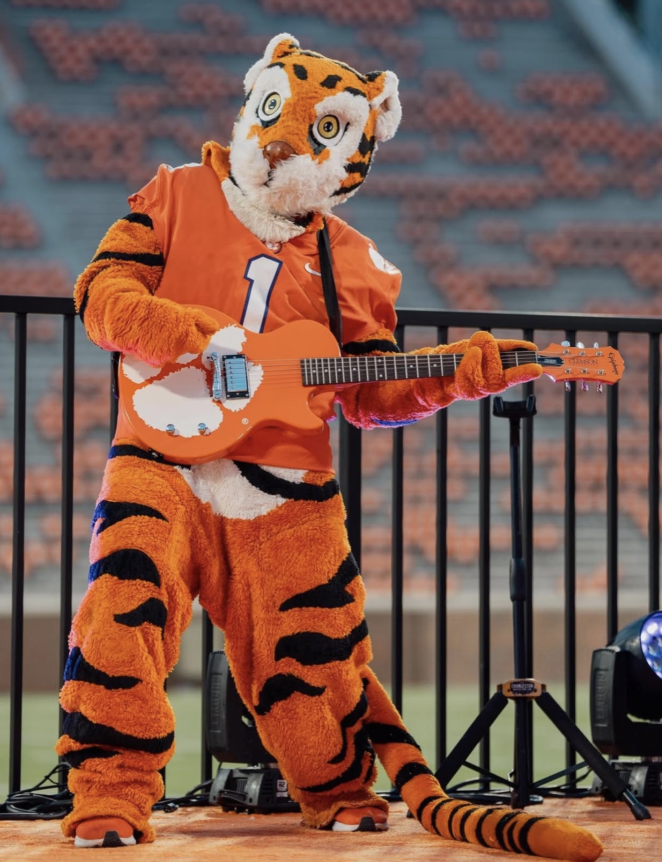 Clemson Tiger mascot with an orange guitar