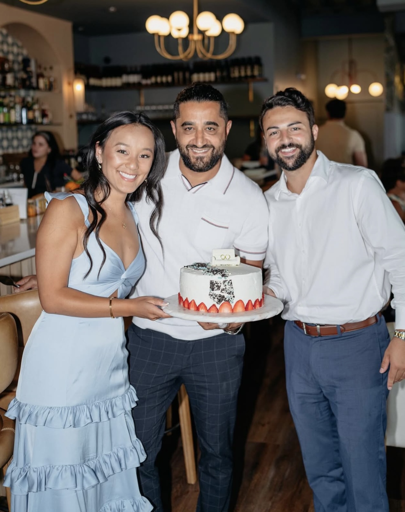 Restaurant owners celebrating a milestone with a custom cake